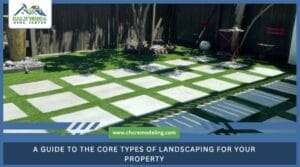 A modern backyard landscape featuring large square concrete pavers set in a grid pattern within a lush green lawn.